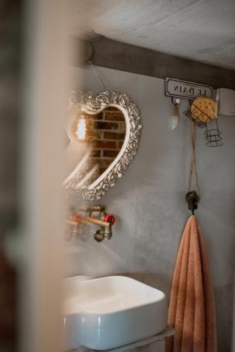 a bathroom with a sink and a mirror on the wall at NATURE HOUSE Pszczyna in Pszczyna