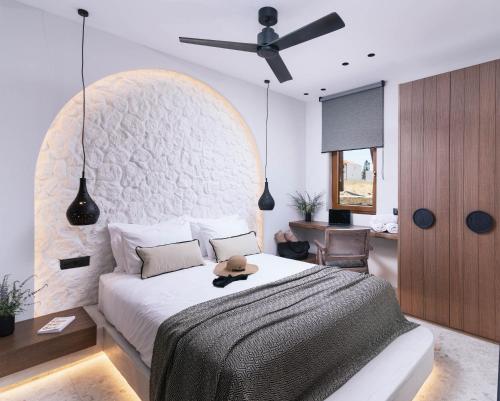 a bedroom with a bed and a ceiling fan at Kedros Katikies in Kalamaki Heraklion