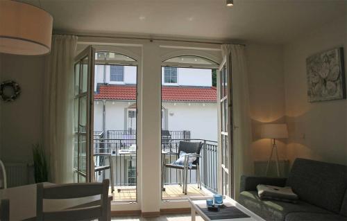 ein Wohnzimmer mit Couch und Balkon in der Unterkunft Haus Meeresblick - Ferienwohnung Am Strand (Ref. 128682u2) in Baabe