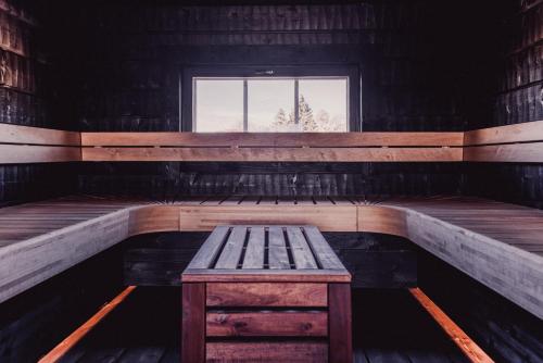 a bench in a wooden room with a window at Brudhäll Hotel & Restaurant in Kökar