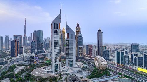 a city skyline with tall buildings and a highway at Jumeirah Emirates Towers in Dubai