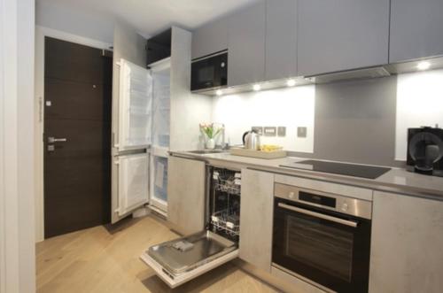 a kitchen with a sink and a stove at Mnitri apartment in Luton