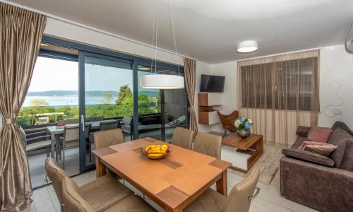 a living room with a table and a couch at Villa Ivan in Sveti Filip i Jakov