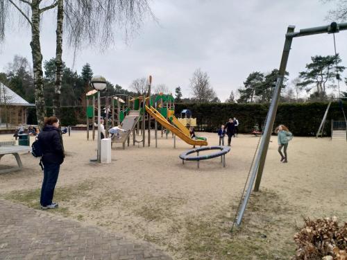 a group of people standing in a playground at De Stamper - De Wije Werelt in Otterlo