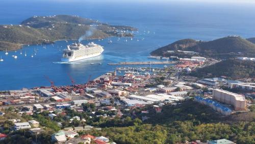 a cruise ship is docked in a harbor at One Seven Solberg in St Thomas