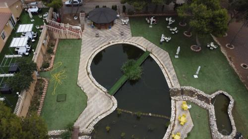 an overhead view of a park with a pond at Hotel El Cisne in Zaragoza