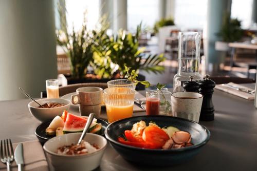 a table topped with bowls of food and drinks at Quality Hotel Harstad in Harstad