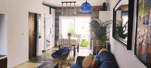 a living room with a couch and a dining room at La Barrosa duplex in Chiclana de la Frontera