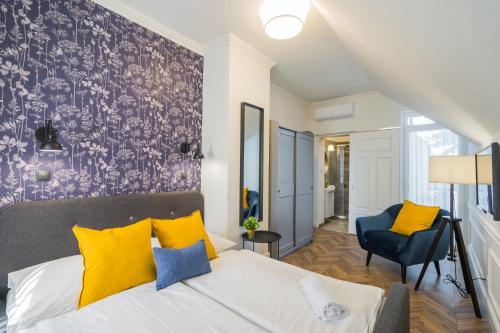 1 dormitorio con 1 cama con almohadas amarillas y azules en Anna Beach Villa, en Siófok