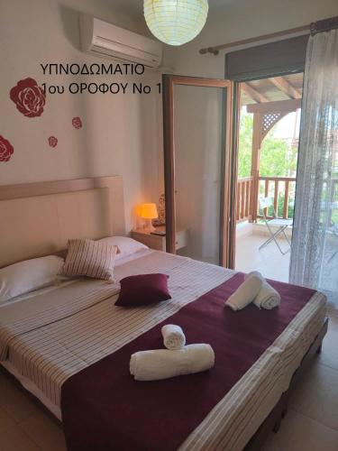 a bedroom with a large bed with towels on it at Maisonette In Paradisos 1 in Neos Marmaras