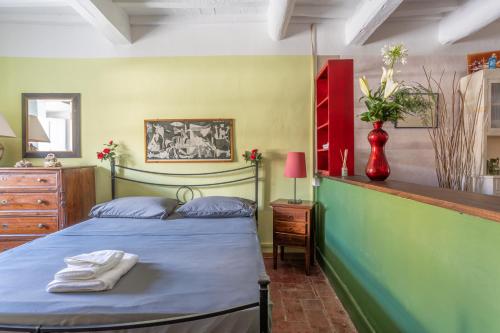 a bedroom with a bed with towels on it at Anfiteatro Lucca in Lucca