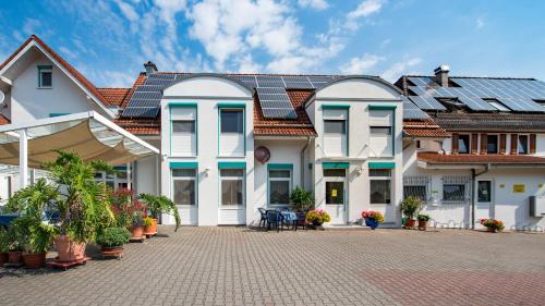 a house with solar panels on its roof at Hotel Adler mit Gasthaus in Haßmersheim