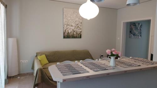 a living room with a table and a couch at Hermes green in Artemida