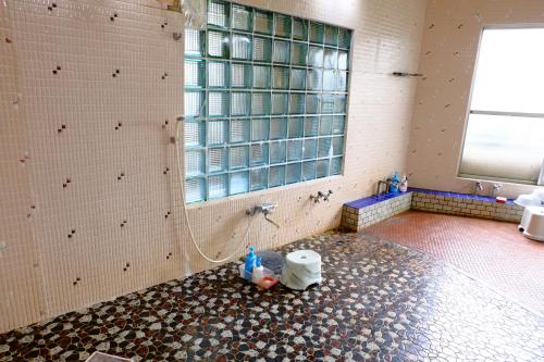 a bathroom with a shower and a sink at Asumi Onsen in Fujiyoshida