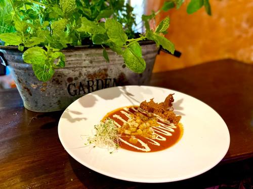 a plate of food on a table with a plant at Troll in Cisna