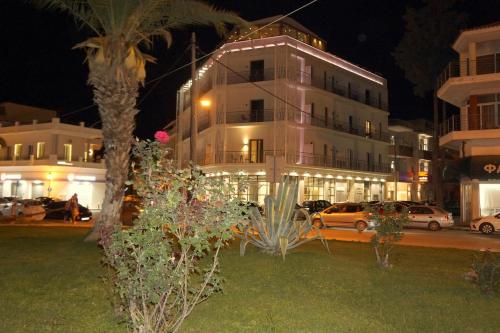 a building with cars parked in front of it at night at Liberty of Nafplio in Nafplio