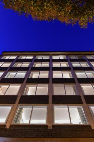 an office building looking up at the sky at Oscar Concept Apartments in Lisbon