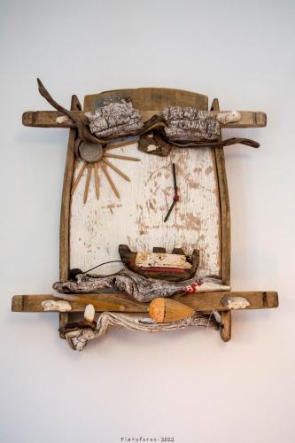 a wooden clock hanging on a wall at Platyforos, in city central of Zakynthos in Zakynthos Town