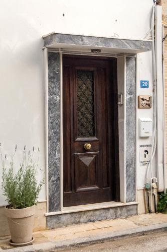 a wooden door on the side of a building at Platyforos, in city central of Zakynthos in Zakynthos Town