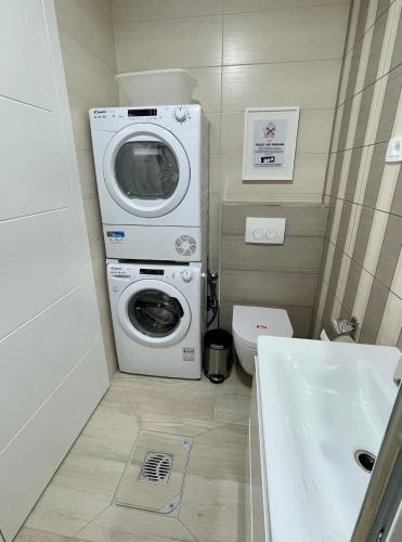 a bathroom with a washing machine and a toilet at Citadela in Primošten