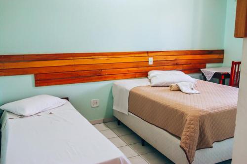 Postel nebo postele na pokoji v ubytování Hotel Pato Branco