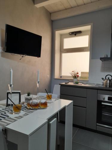 a kitchen with a table with some food on it at Maison Ane Marie in Avola