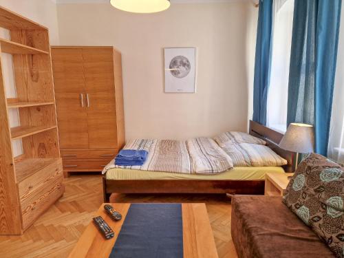 a small room with two beds and a couch at Apartament księżycowy in Toruń