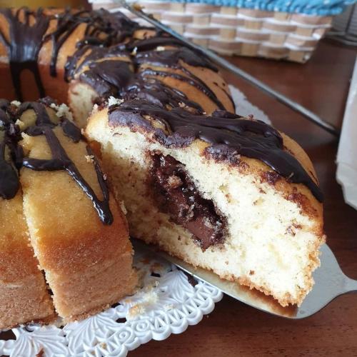 two pieces of cake on a plate with chocolate icing at Chalet del Mare in Porto Cesareo
