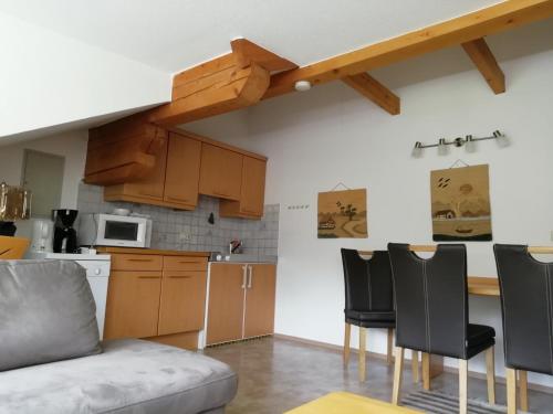 a kitchen with a table and chairs in a room at Pension Strauss in Sankt Lorenzen ob Murau