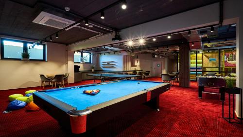 a pool table in a room with ping pong balls at Resorts H Białka Tatrzańska z sauną, Sun & Snow in Białka Tatrzanska