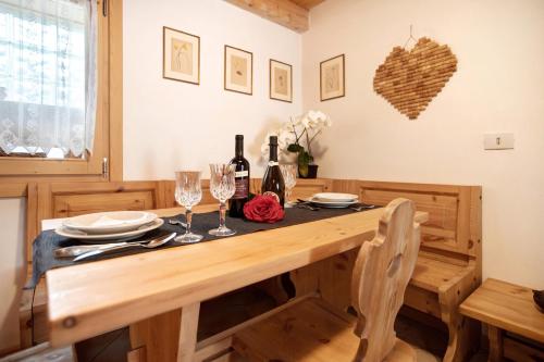 a dining room table with wine bottles and glasses at Taulain Gotrosio in Valdisotto