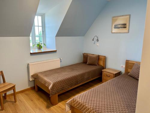 Кровать или кровати в номере Pakėvio dvaras - Pakevis manor