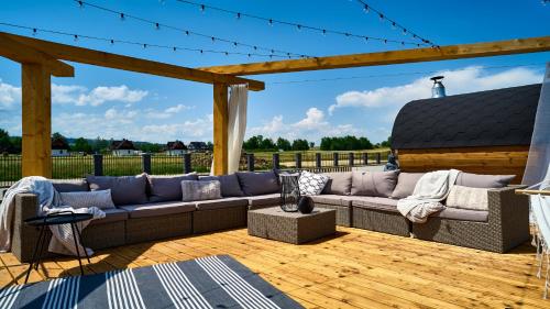 a large couch sitting on a wooden deck at Resorts H Białka Tatrzańska z sauną, Sun & Snow in Białka Tatrzanska