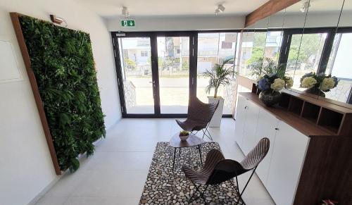 a lobby with chairs and a table in a building at Villa Ivan in Sveti Filip i Jakov