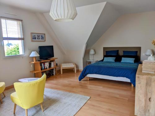 - une chambre avec un lit bleu et une chaise jaune dans l'établissement Les Hautes Marnes Proche circuit, à Saint-Gervais en-Belin