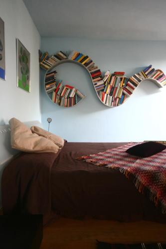a bedroom with a bed and a mirror on the wall at A Casa di Maria in Grinzane Cavour