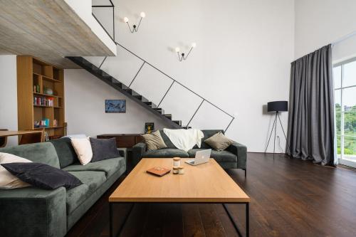 a living room with a couch and a table at Villa Volare Cantare with 2 br, a heated pool and panoramic view near Buje, Istra in Momjan