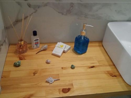 a wooden floor with a blue bottle and other items on it at George & Dimitra's House in Kharokopión