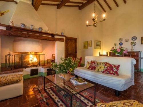 a living room with a white couch and a table at Podere del mezzadro in Contignano