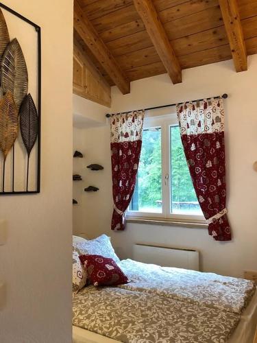 a bedroom with a bed and a window at Alloggio agrituristico Pociat in Pradis
