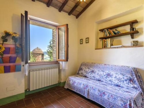 a bedroom with a bed and a window with a view at Podere del mezzadro in Contignano