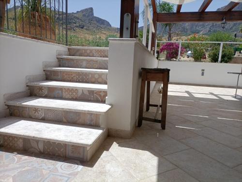 a set of stairs with a table next to it at Casolare La Torre in Scopello