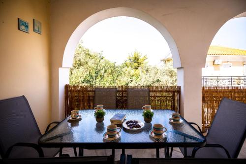 a table in a room with two arched windows at Levante Breeze in Xirokástellon