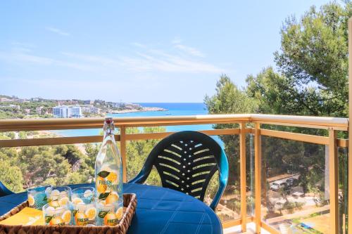 a table and chairs on a balcony with a view of the ocean at UHC Cala Dorada in Salou