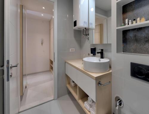a bathroom with a sink and a shower at Luxury Studio Yasmine Downtown in Mostar
