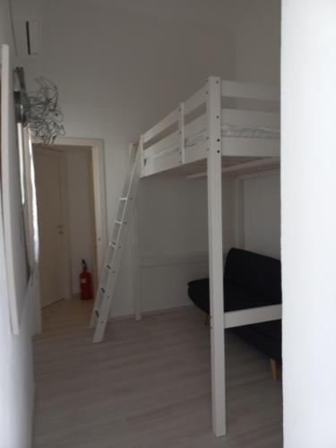 a white bunk bed in a room with a ladder at Casetta Iacono camera Pithecusa in Ischia