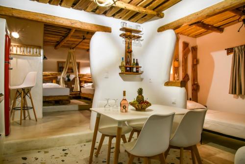 a dining room with a table and chairs and a bedroom at Hada Milos suite in Firopótamos