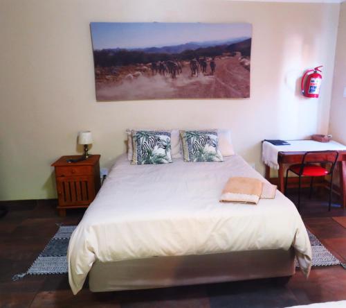 En eller flere senge i et værelse på Huis Afrika