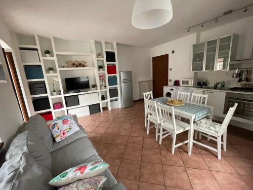 a living room with a couch and a table and chairs at Casavacanze IL GALLO in Omegna