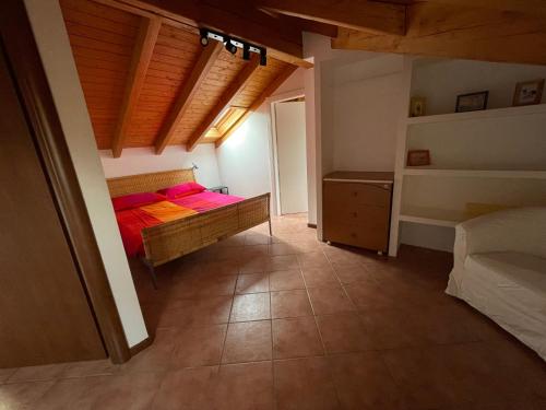 a bedroom with two beds in a room with wooden ceilings at Casavacanze IL GALLO in Omegna
